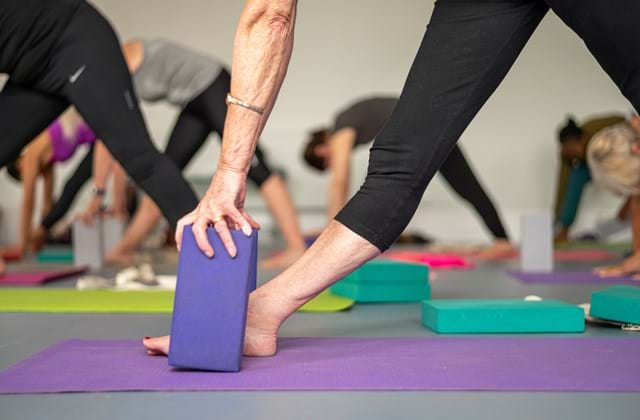 Feet and support blocks during a yoga class