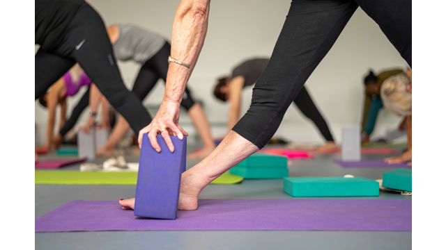 Feet and support blocks during a yoga class