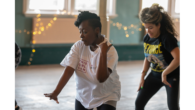 Two women dancing in an exercise class