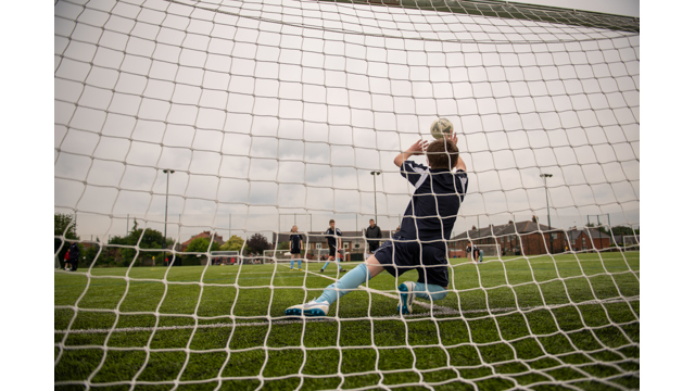 Child trying to save a football shot