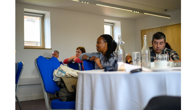 People sat around tables at a workshop