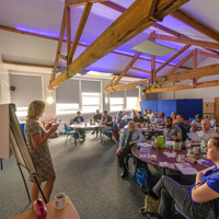 Group of people in a workshop looking at the tutor