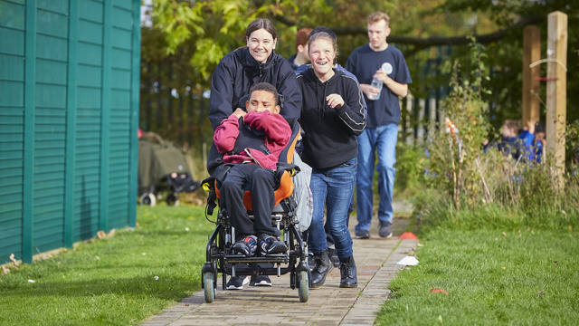 Adults and young people taking part in the daily mile on an outdoor path