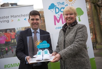 Andy Burnham and Elaine Wyllie holding a pair of Daily Mile branded plimsolls