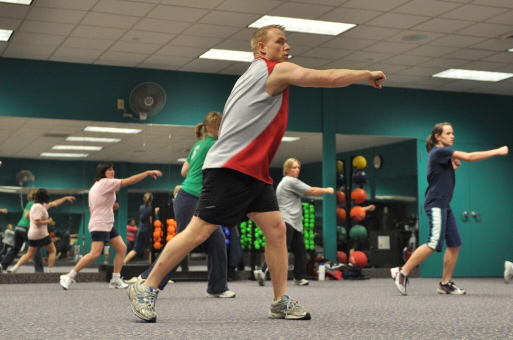 Adults exercise in a group class at a leisure centre