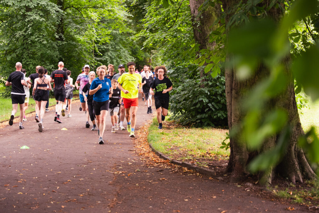 A group of people running through a park