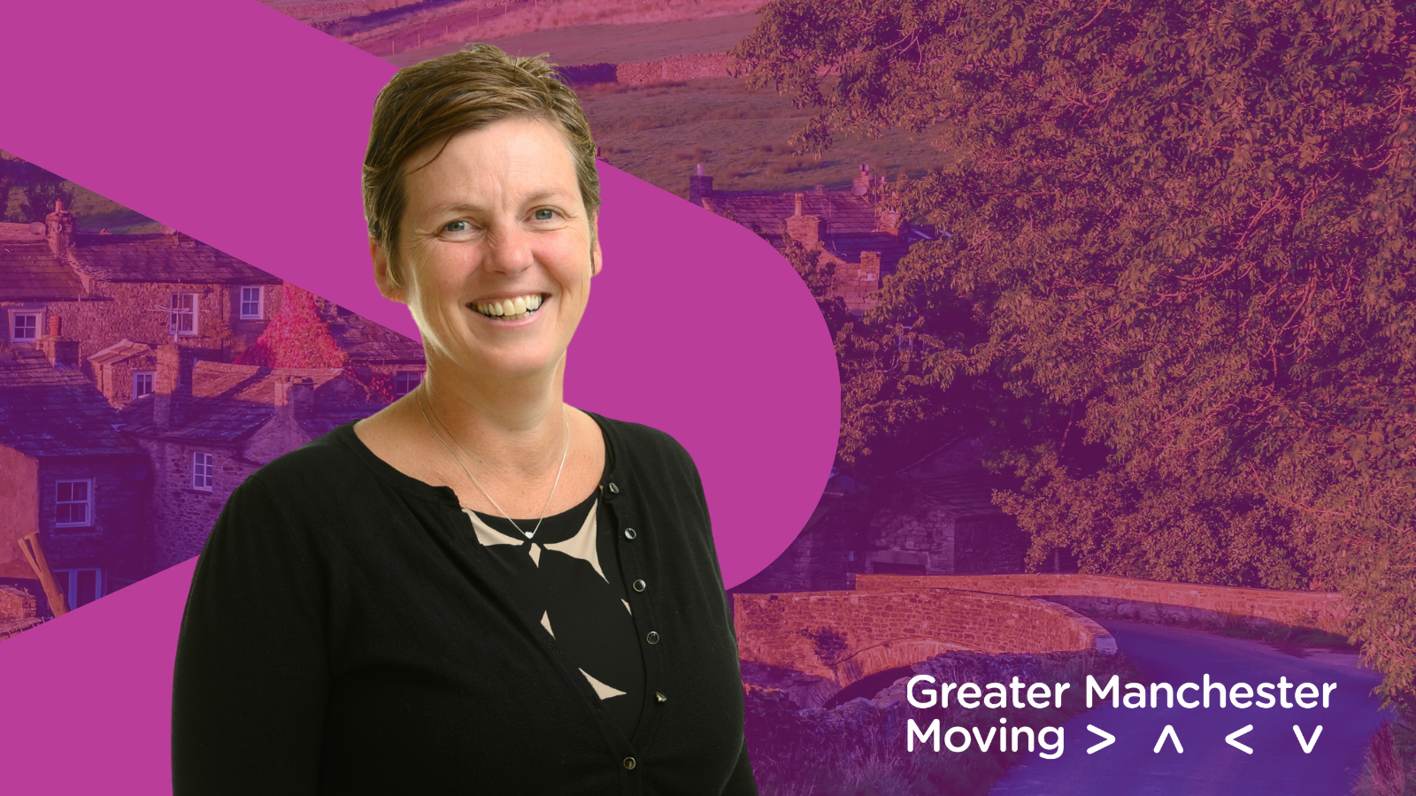 Hayley Lever smiles in front of a GM Moving branded purple background