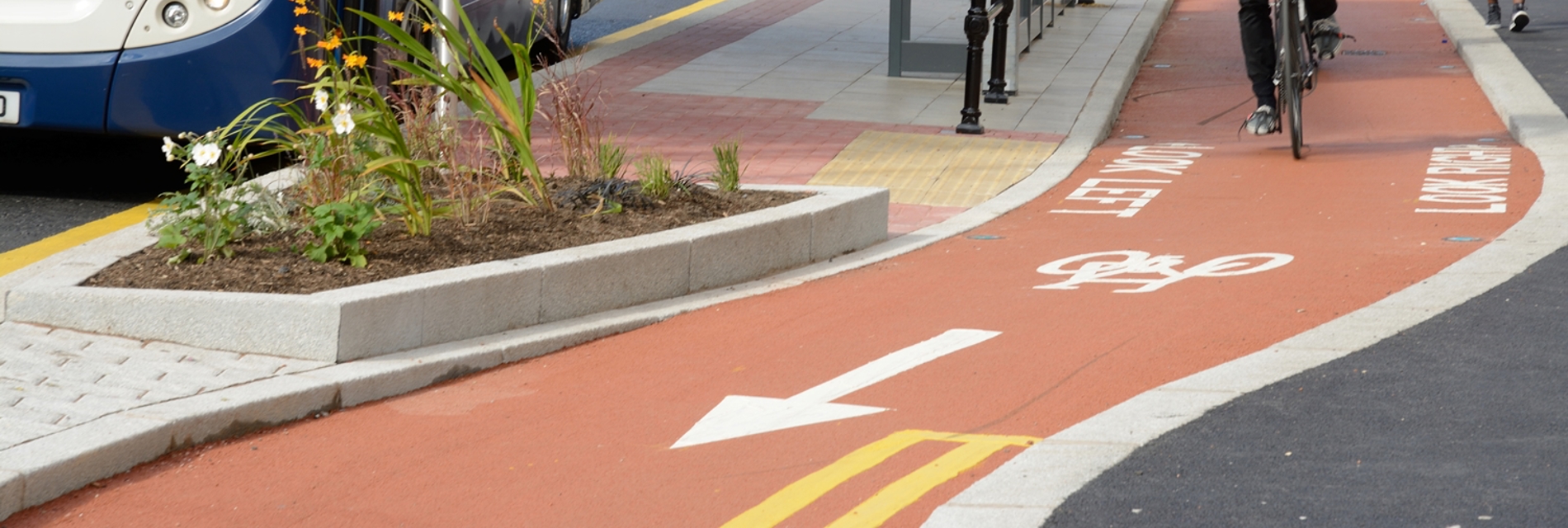 Cyclists use the Oxford Road cycle lane in Manchester, near a bus stop