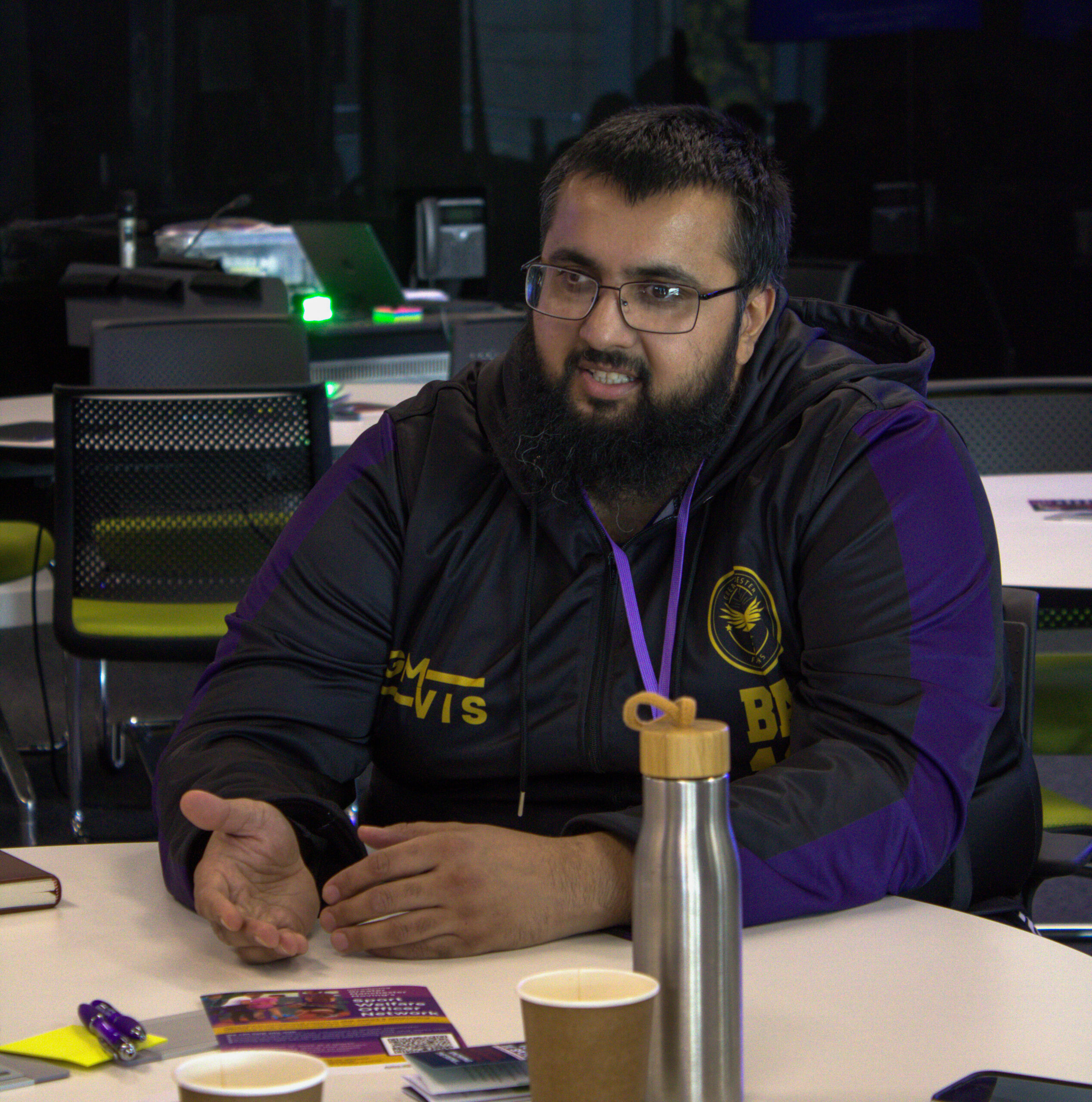 A community sport leader talks to colleagues at a conference