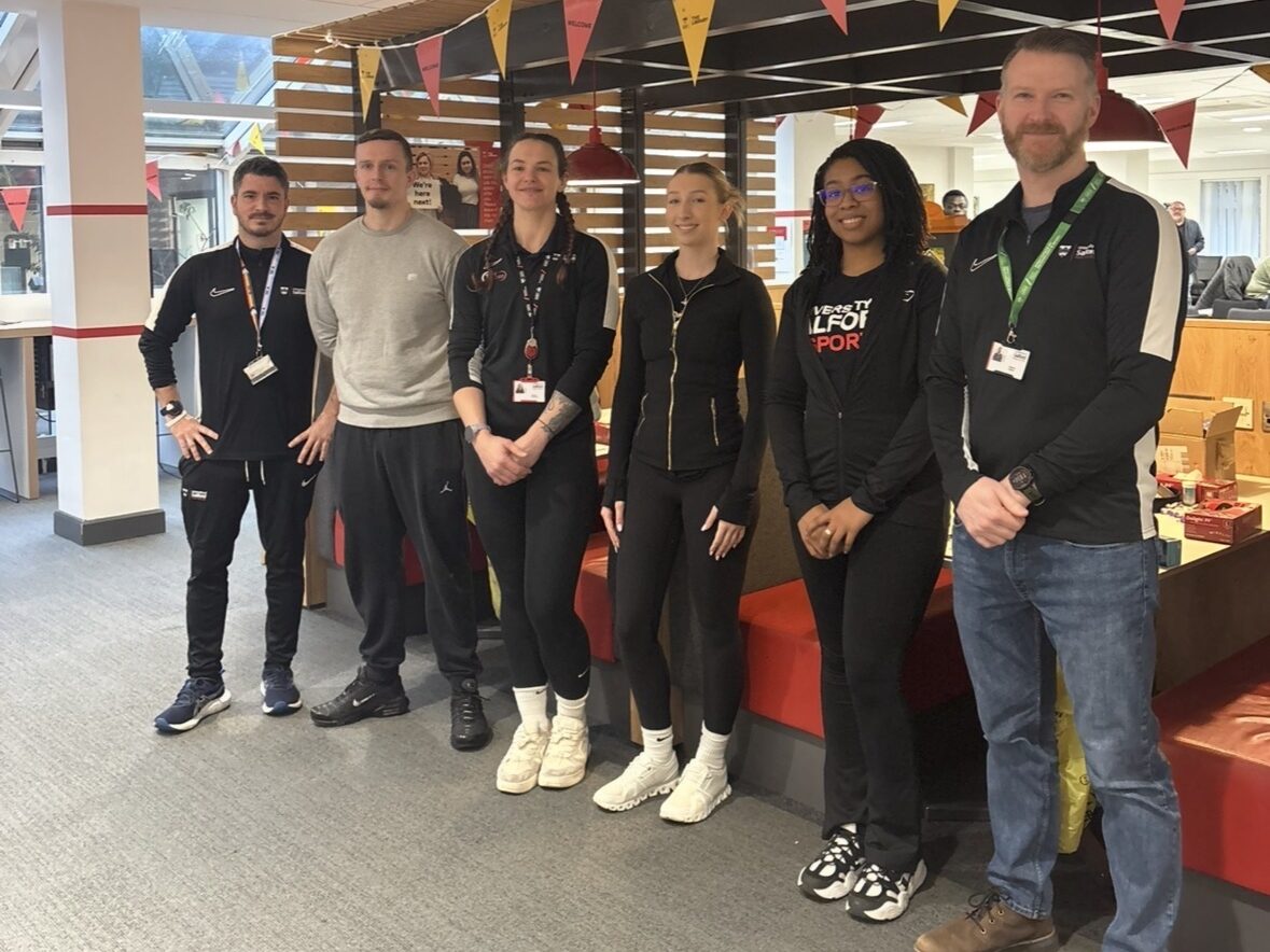A group of adults stand for a group photo