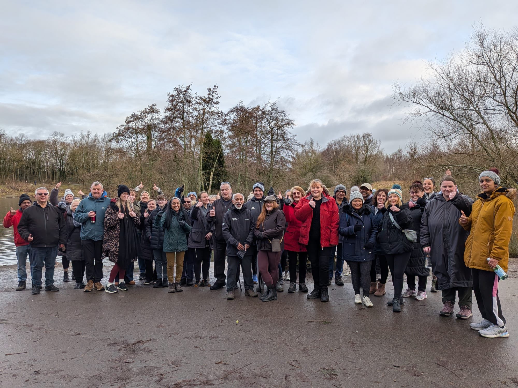 group of people outside standing in a semi circle smiling and happy