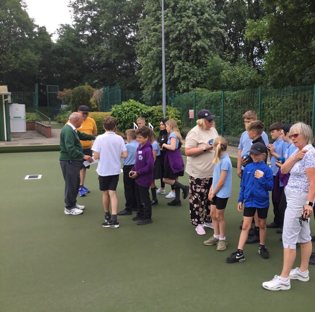 Young People playing bowls at Leverhulme and Bolton Flat Greens Club