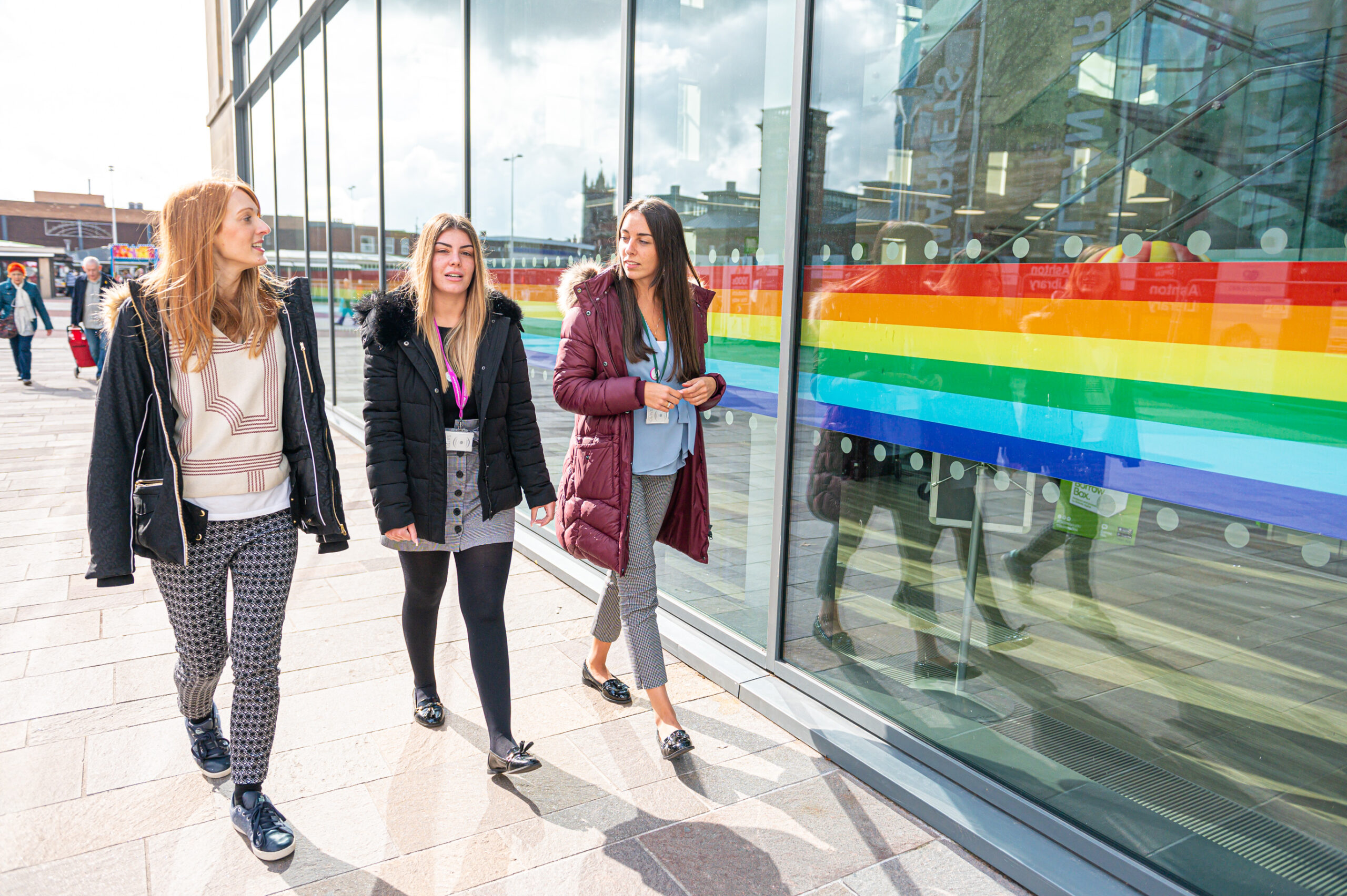 Three employees walk outside on their way to an office