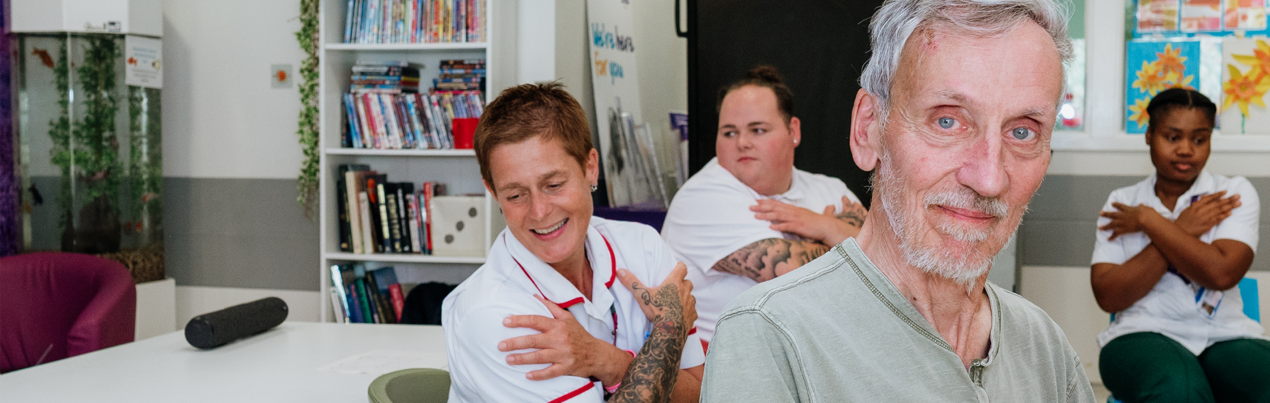 a person participates in a movement exercise led by nurses